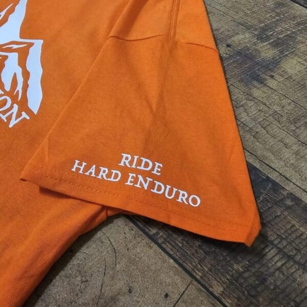 A close up of the side of an orange umbrella
