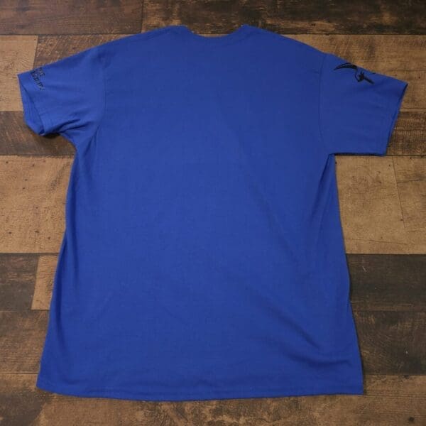 A blue shirt is sitting on the ground