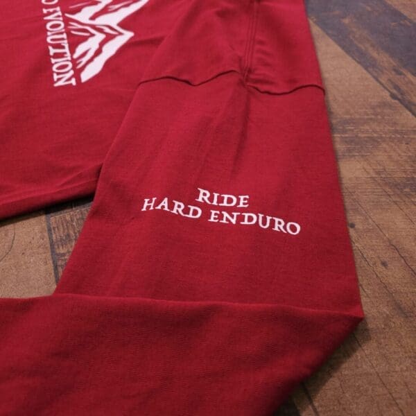 A red shirt that says ride hard enduro