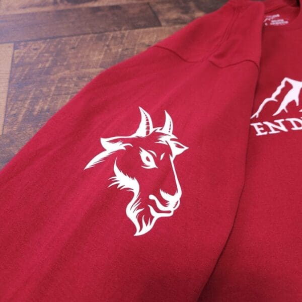 A close up of the goat 's head on a red jacket.
