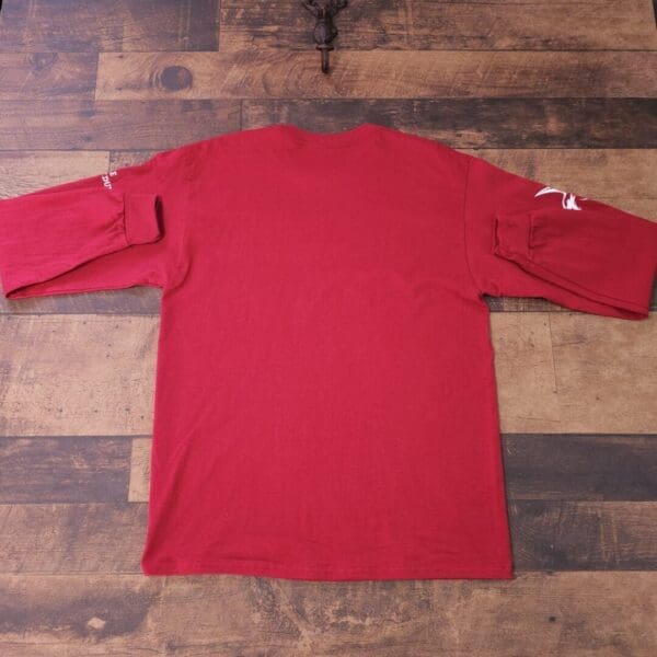 A red shirt is sitting on the ground