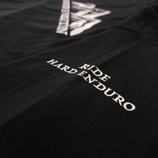 A close up of the words ride hardenduro on a black shirt