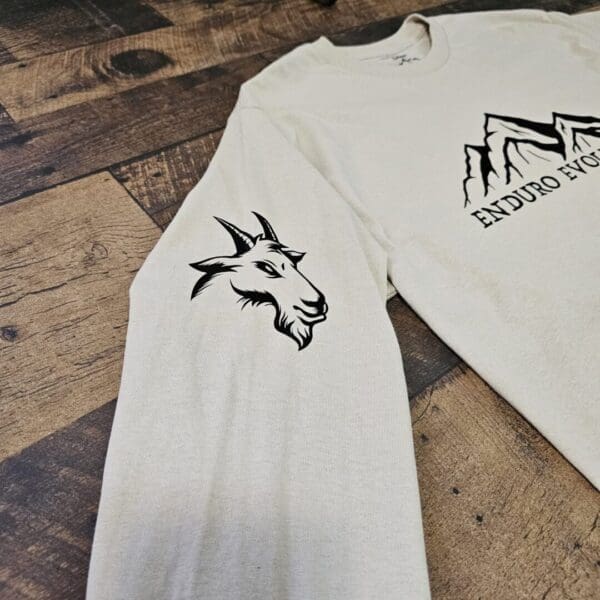 A white shirt with a goat on it