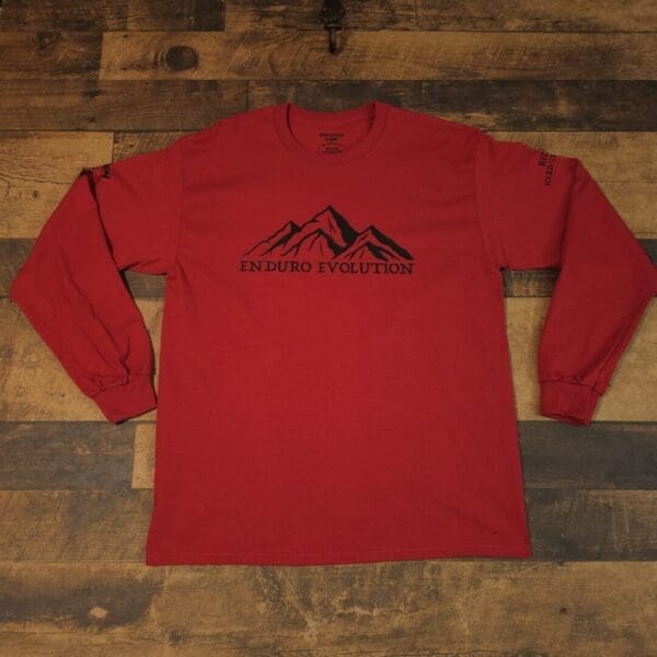 A red long sleeve shirt with mountains on it.