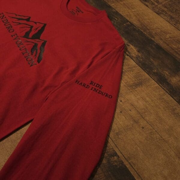 A red shirt with black writing on it