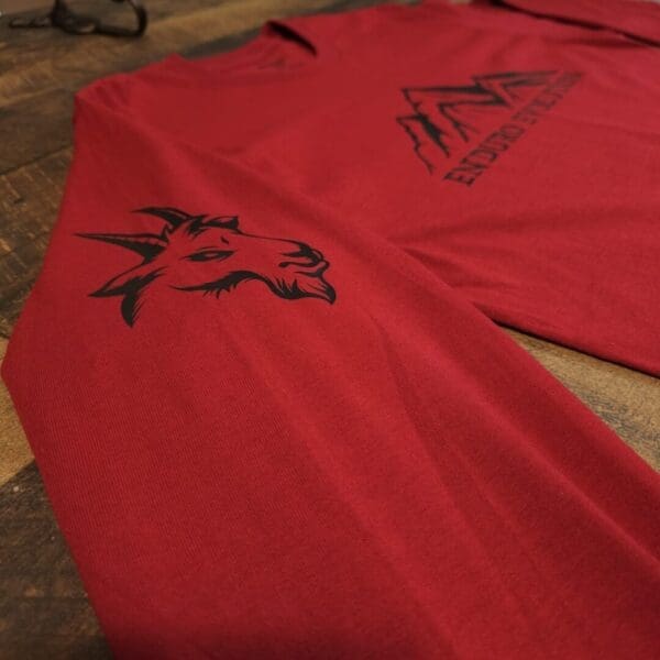 A red shirt with black writing on it