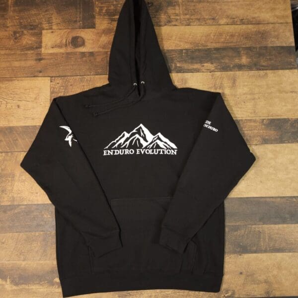 A black hoodie with a mountain on it.