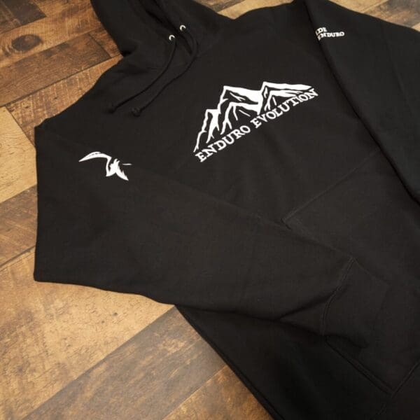 A black shirt with a mountain logo on it.