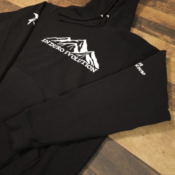 A black long sleeve shirt with a mountain on it.