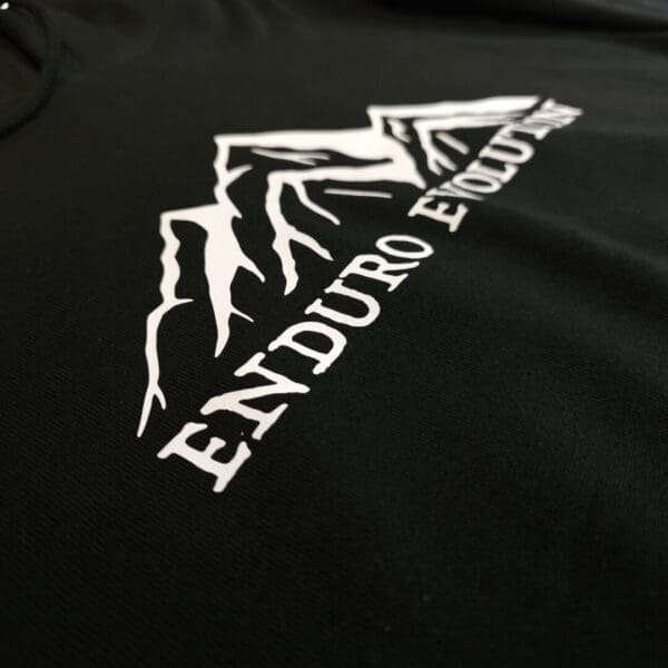 A close up of the logo on a black shirt