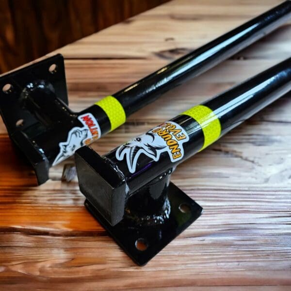 A pair of black and yellow poles on top of a wooden table.